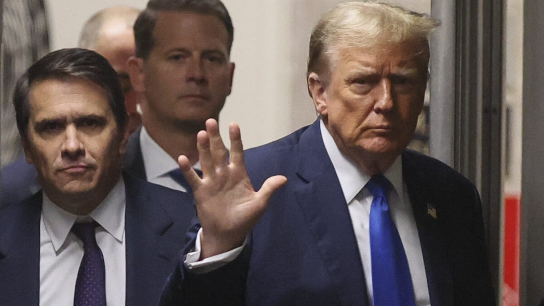 Former US President Donald Trump gestures as he returns from a recess in his trial for allegedly covering up hush money payments linked to extramarital affairs, at Manhattan Criminal Court in New York City on April 18, 2024. Trump's criminal trial resumes Thursday with Judge Juan Merchan seeking to complete jury selection. Moving the US into uncharted waters, it is the first criminal trial of a former US president, one who is also battling to retake the White House in November.