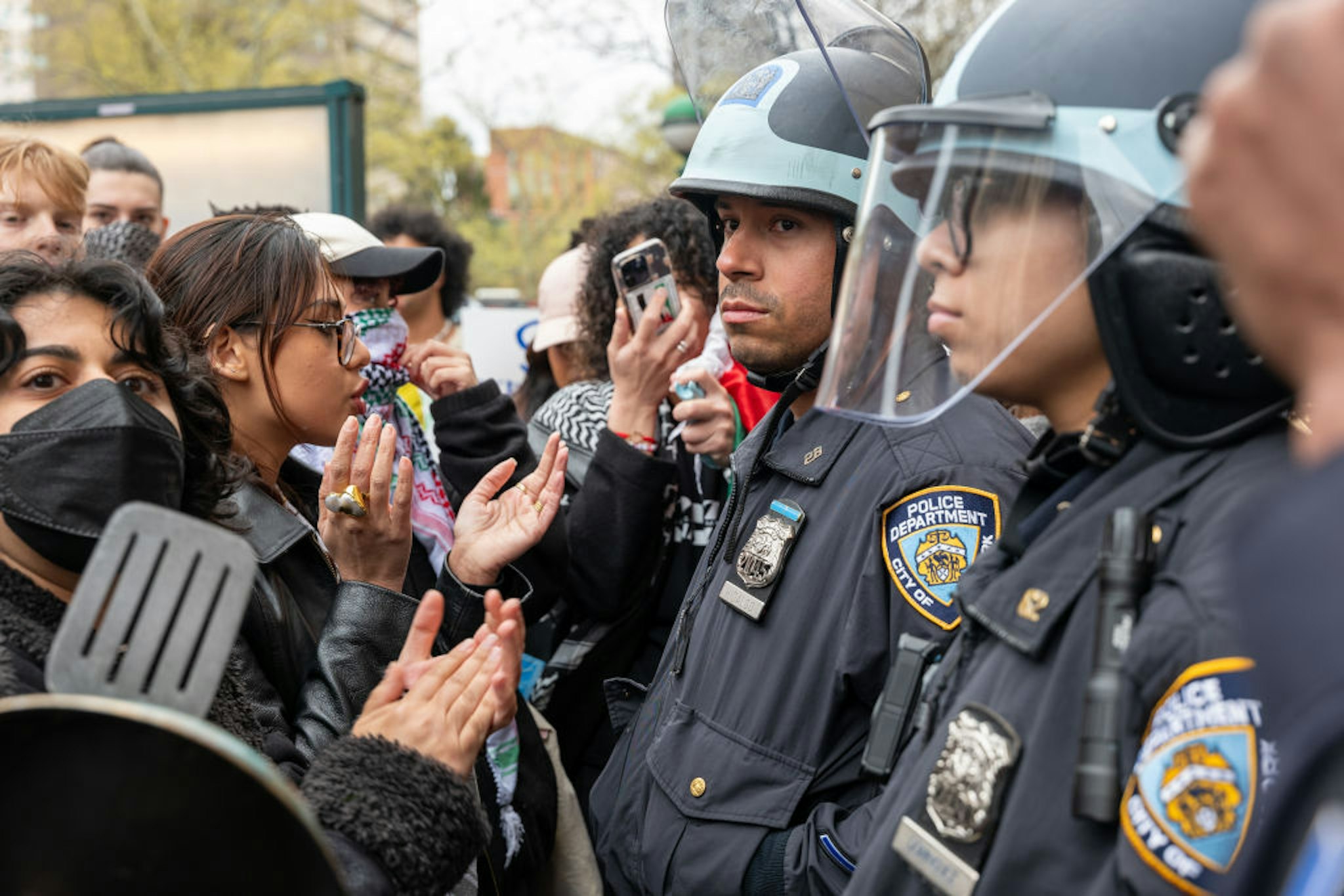 NEW YORK, NEW YORK - APRIL 18: Students and pro-Palestinian activists face police as they gather outside of Columbia University to protest the university's stance on Israel on April 18, 2024 in New York City. The protests come after numerous students were arrested earlier in the day after setting up tents on the university lawn in support of Gaza. (Photo by Spencer Platt/Getty Images)