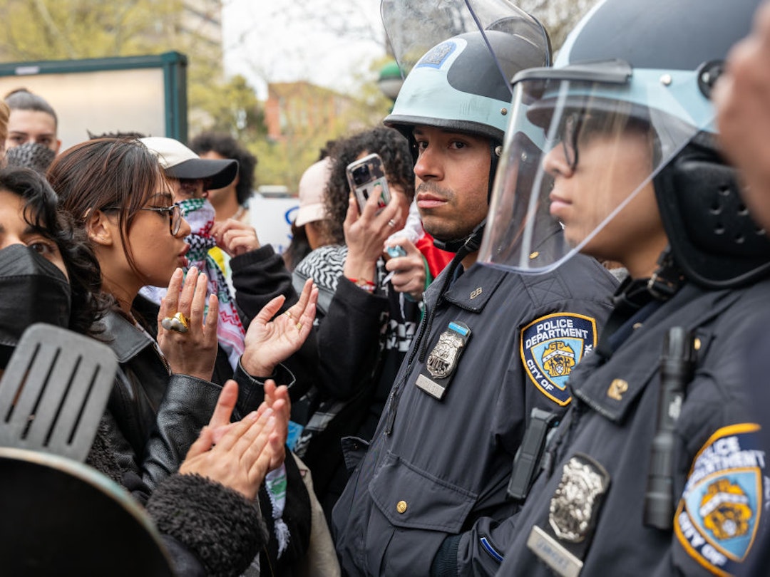 NEW YORK, NEW YORK - APRIL 18: Students and pro-Palestinian activists face police as they gather outside of Columbia University to protest the university's stance on Israel on April 18, 2024 in New York City. The protests come after numerous students were arrested earlier in the day after setting up tents on the university lawn in support of Gaza. (Photo by Spencer Platt/Getty Images)
