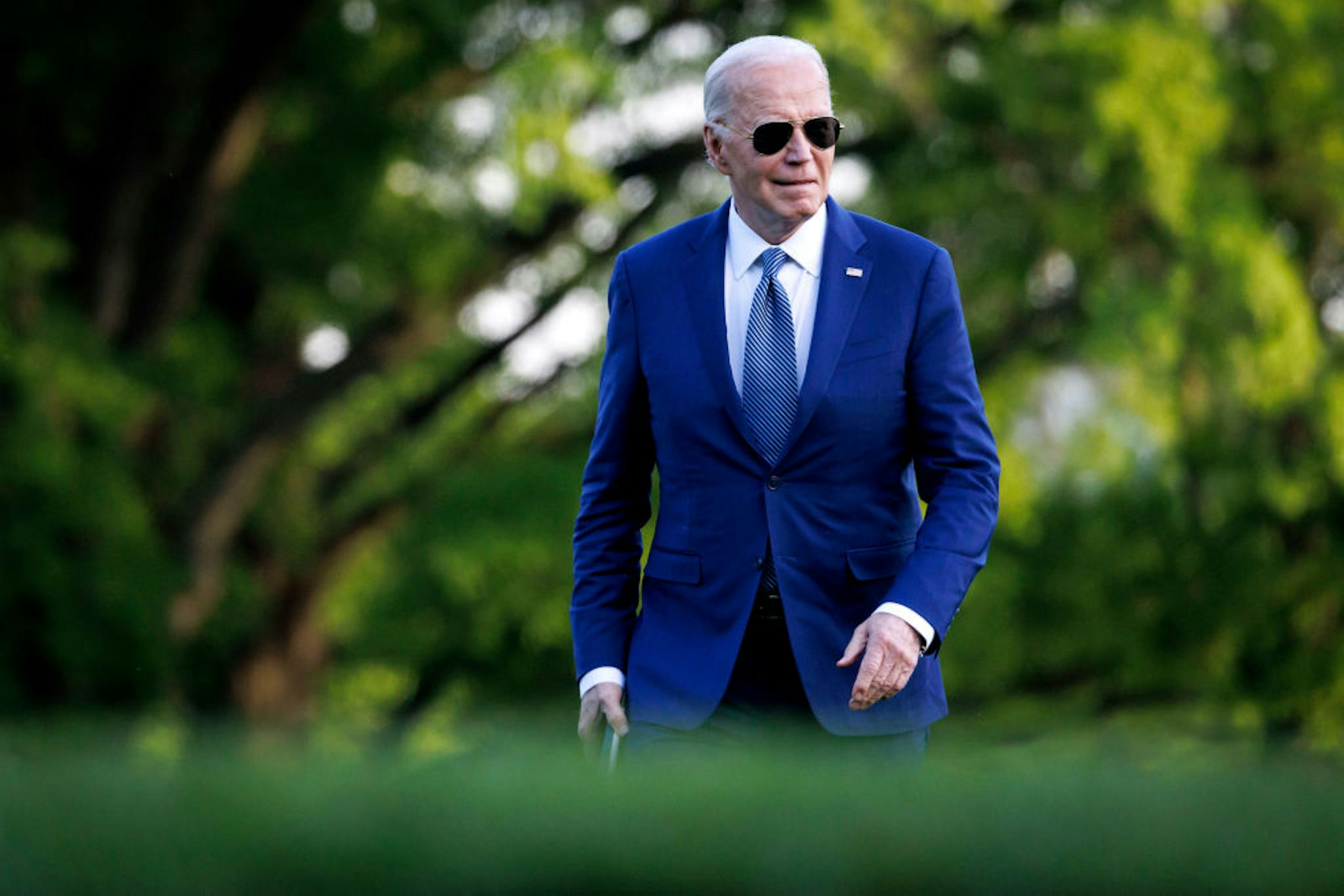 US President Joe Biden walks on the South Lawn of the White House after arriving on Marine One in Washington, DC, US, on Tuesday, April 23, 2024. The White House is set to announce $1 billion in fresh military aid for Ukraine including 155mm artillery shells and air-defense munitions, two administration officials said, as the US looks to act quickly once a long-delayed supplemental funding request becomes law. Photographer: Ting Shen/Bloomberg via Getty Images
