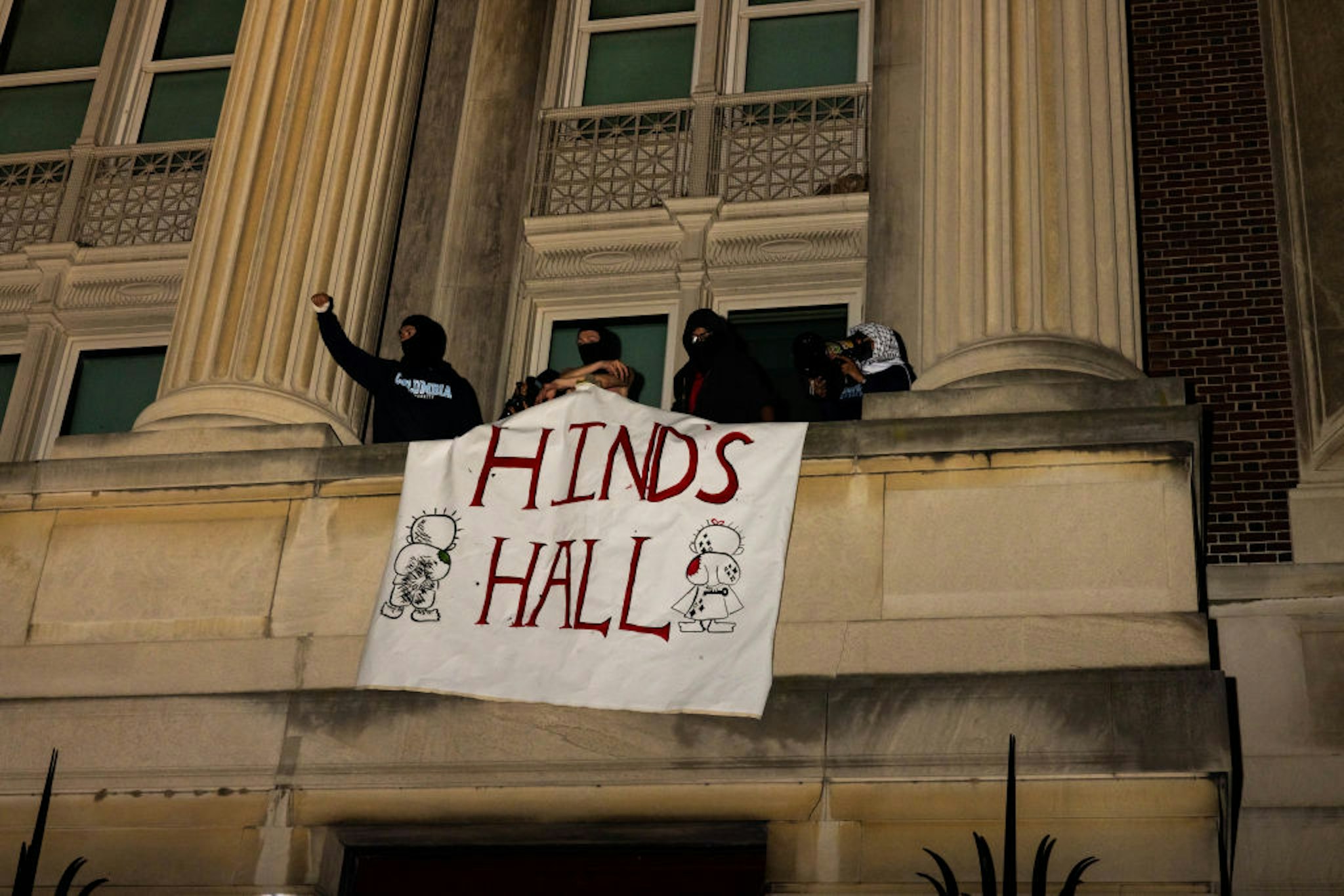 NEW YORK, NEW YORK - APRIL 29: Demonstrators from the pro-Palestine encampment on Columbia's Campus show a banner as they barricade themselves inside Hamilton Hall, they barricade themselves inside Hamilton Hall, an academic building which has been occupied in past student movements,, and name it after a Palestinian child allegedly killed by the Israeli military on Tuesday, April 30, 2024 in New York City. Pro-Palestinian demonstrators marched around the "Gaza Solidarity Encampment" at Columbia University as a 2 P.M. deadline to clear the encampment given to students by the university passed. The students were given a suspension warning if they do not meet the deadline. Columbia students were the first to erect an encampment in support of Palestine, with students demanding that the school divest from Israel amid the Israel-Hamas war, where more than 34,000 Palestinians have been killed in the Gaza Strip.