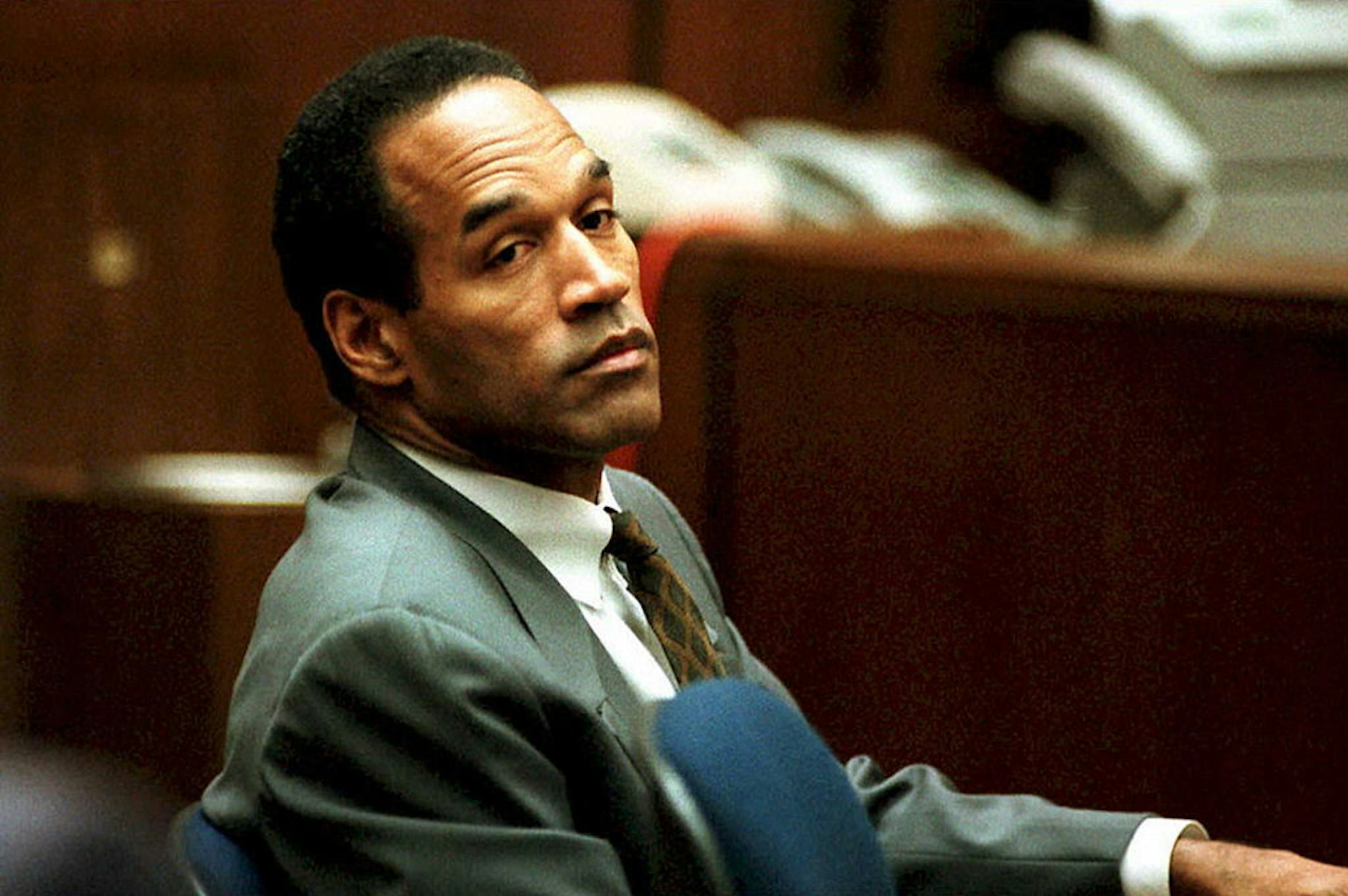 LOS ANGELES, CA - DECEMBER 8: O. J. Simpson sits in Superior Court in Los Angeles 08 December 1994 during an open court session where Judge Lance Ito denied a media attorney's request to open court transcripts from a 07 December private meeting involving prospective jurors. Final selection of alternate jurors by attorneys in the double murder case is expected later this afternoon. (Photo credit should read POOL/AFP via Getty Images)