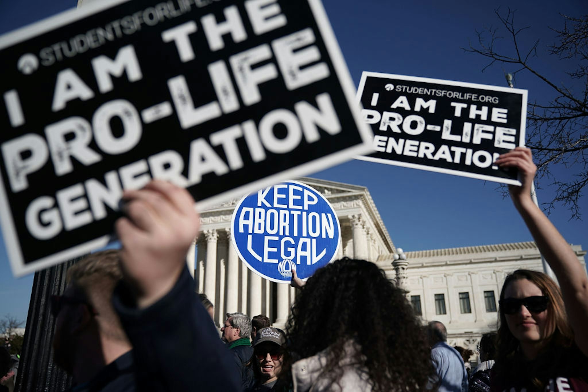 WASHINGTON, DC - JANUARY 19: Pro-life activists try to block the sign of a pro-choice activist during the 2018 March for Life January 19, 2018 in Washington, DC. Activists gathered in the nation's capital for the annual event to protest the anniversary of the Supreme Court Roe v. Wade ruling that legalized abortion in 1973.