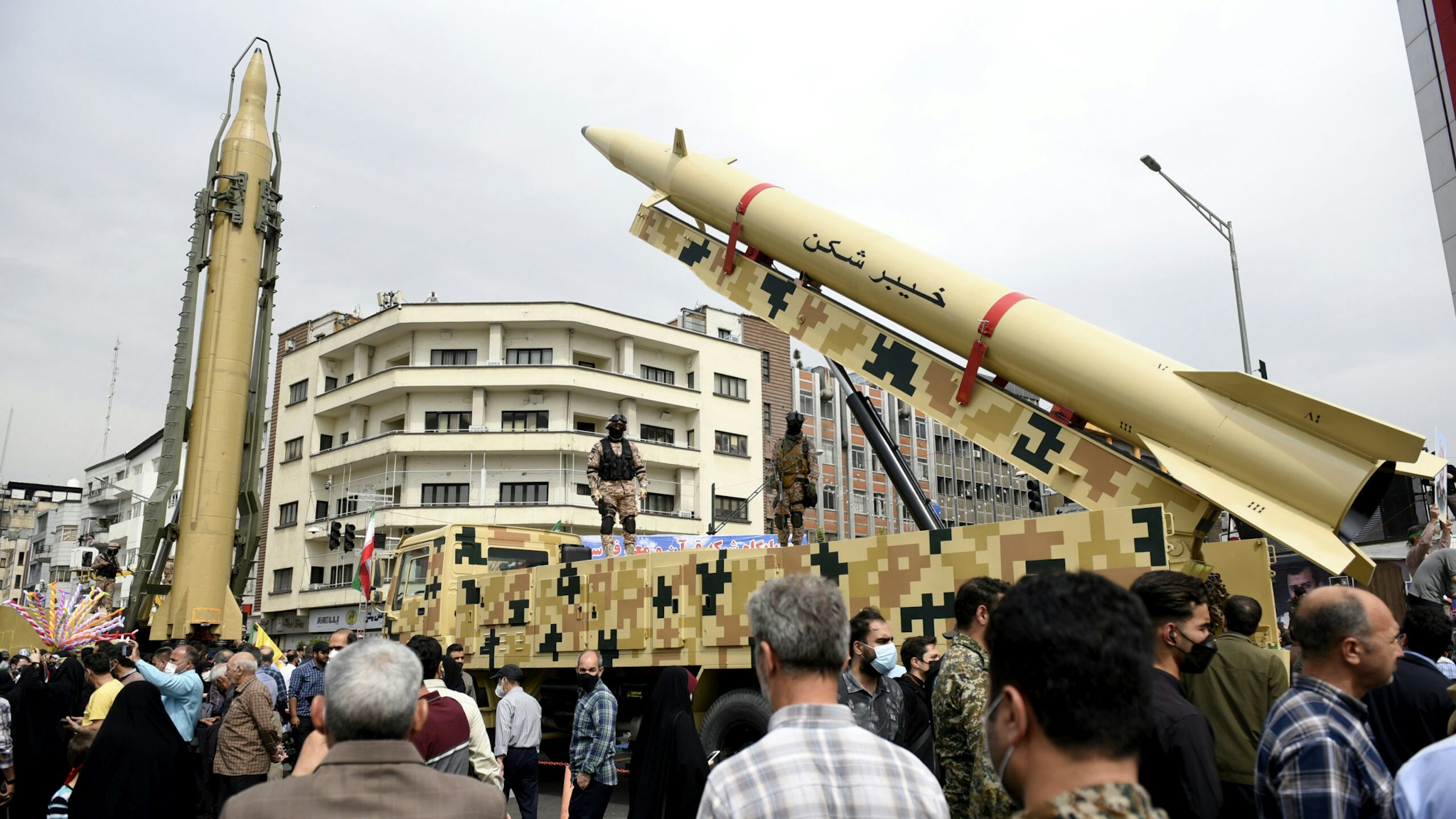 TEHRAN, IRAN - 2022/04/29: "Shahab-3", left, and "Khaibar-buster" missiles displayed during the annual pro-Palestinians Al-Quds or Jerusalem Day rally in Tehran. "Khaibar-buster" is the world's longest-range tactical ballistic missile with a range of 1,450 km. The 'Kheiber-Shekan' strategic missile is one of the long-range missiles of the Islamic Revolutionary Guard Corps (IRGC).
