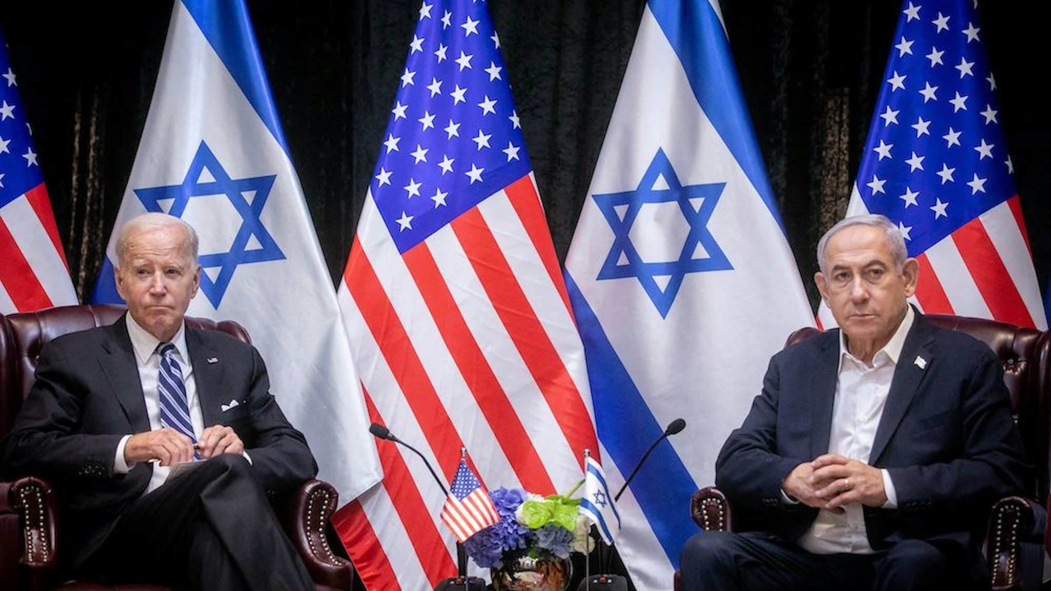 US President Joe Biden (L), sits with Israeli Prime Minister Benjamin Netanyahu, at the start of the Israeli war cabinet meeting, in Tel Aviv on October 18, 2023, amid the ongoing battles between Israel and the Palestinian group Hamas. (Photo by MIRIAM ALSTER/POOL/AFP via Getty Images)