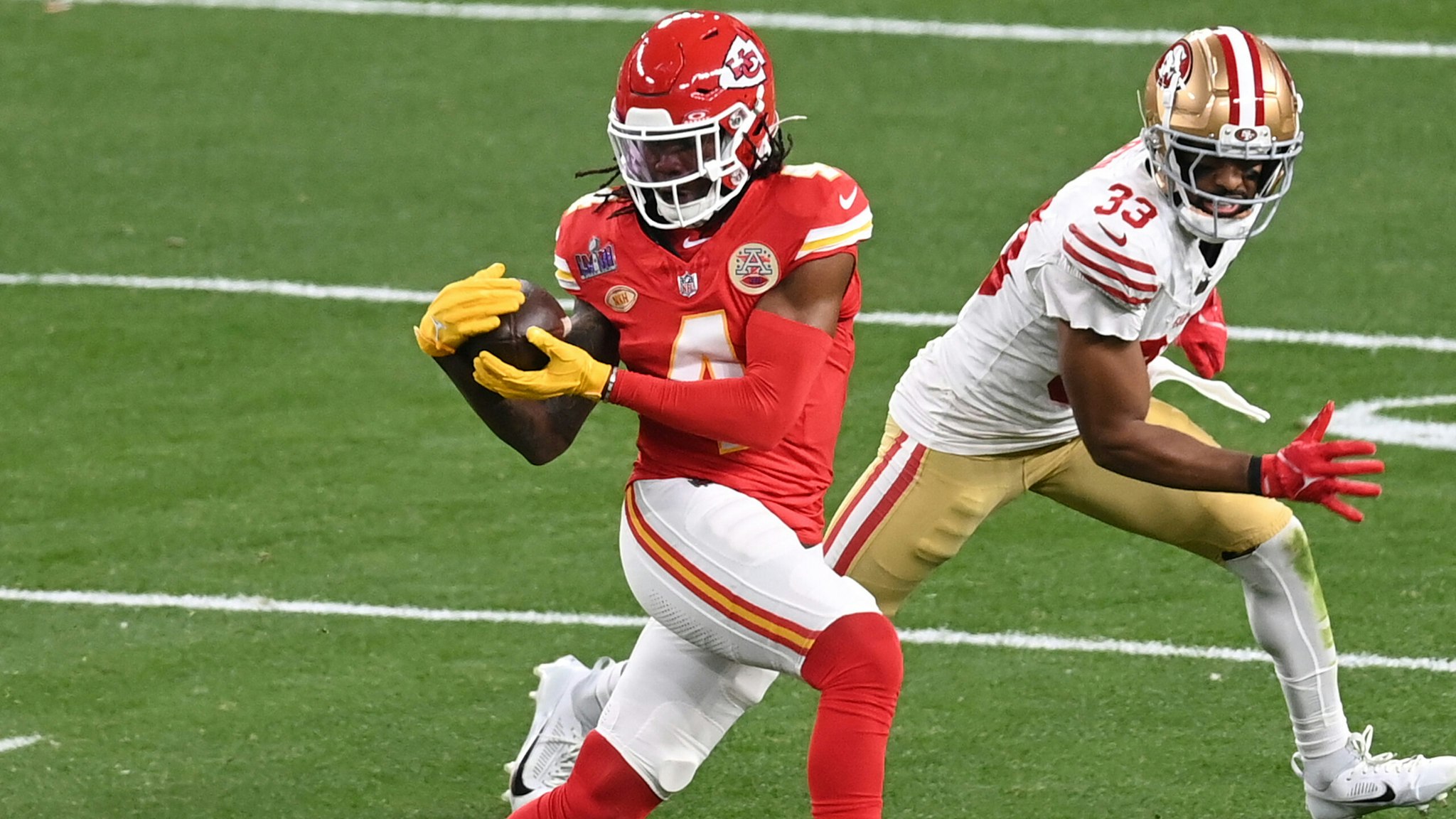 LAS VEGAS, NEVADA - FEBRUARY 11: Rashee Rice #4 of the Kansas City Chiefs catches a pass in front of Logan Ryan #33 of the San Francisco 49ers during Super Bowl LVIII at Allegiant Stadium on February 11, 2024 in Las Vegas, Nevada.