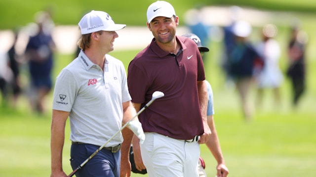 Sam Burns of the United States walks with Scottie Scheffler of the United States on the fourth hole during a practice round prior to the 2023 PGA Championship at Oak Hill Country Club on May 15, 2023 in Rochester, New York.
