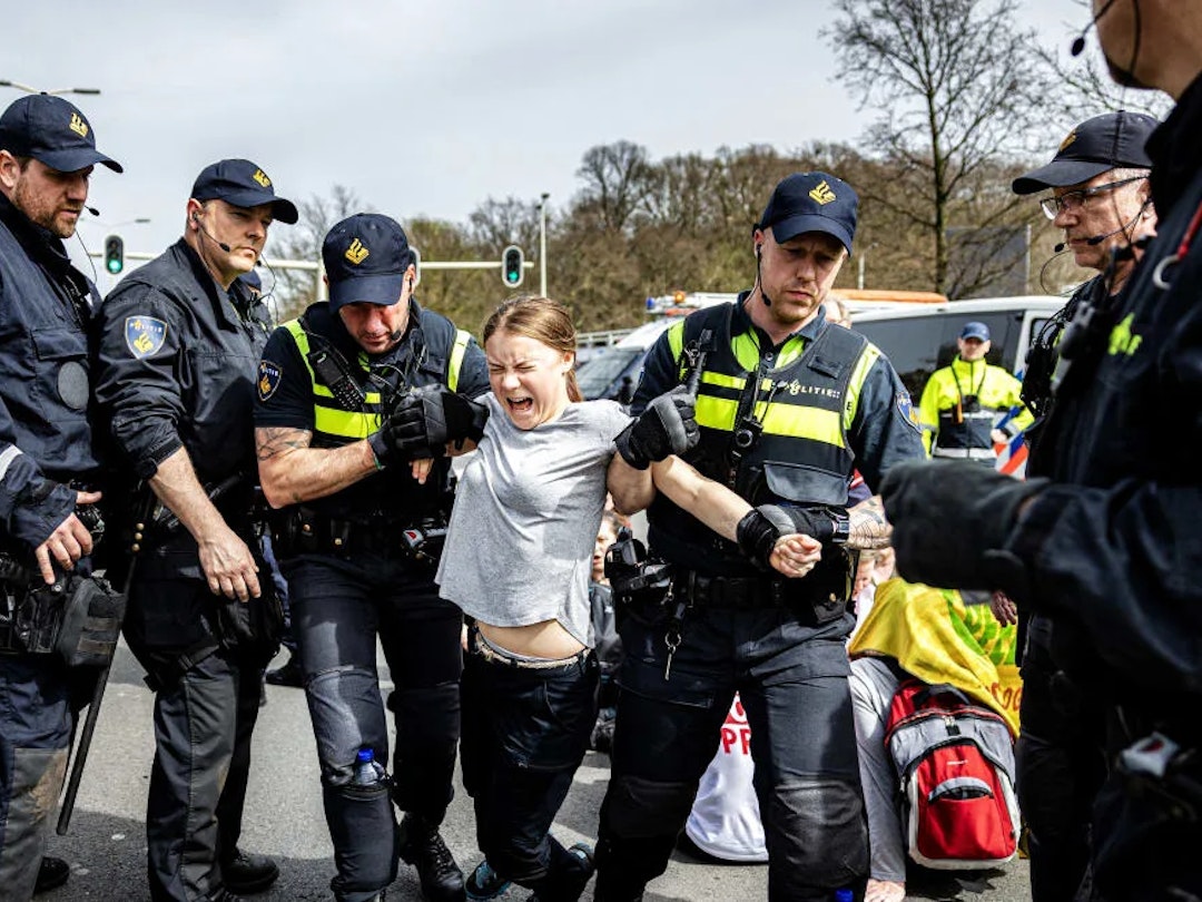Ramon Von Flymen. Getty Images. Greta Thunberg being arrested at a protest at The Hague.