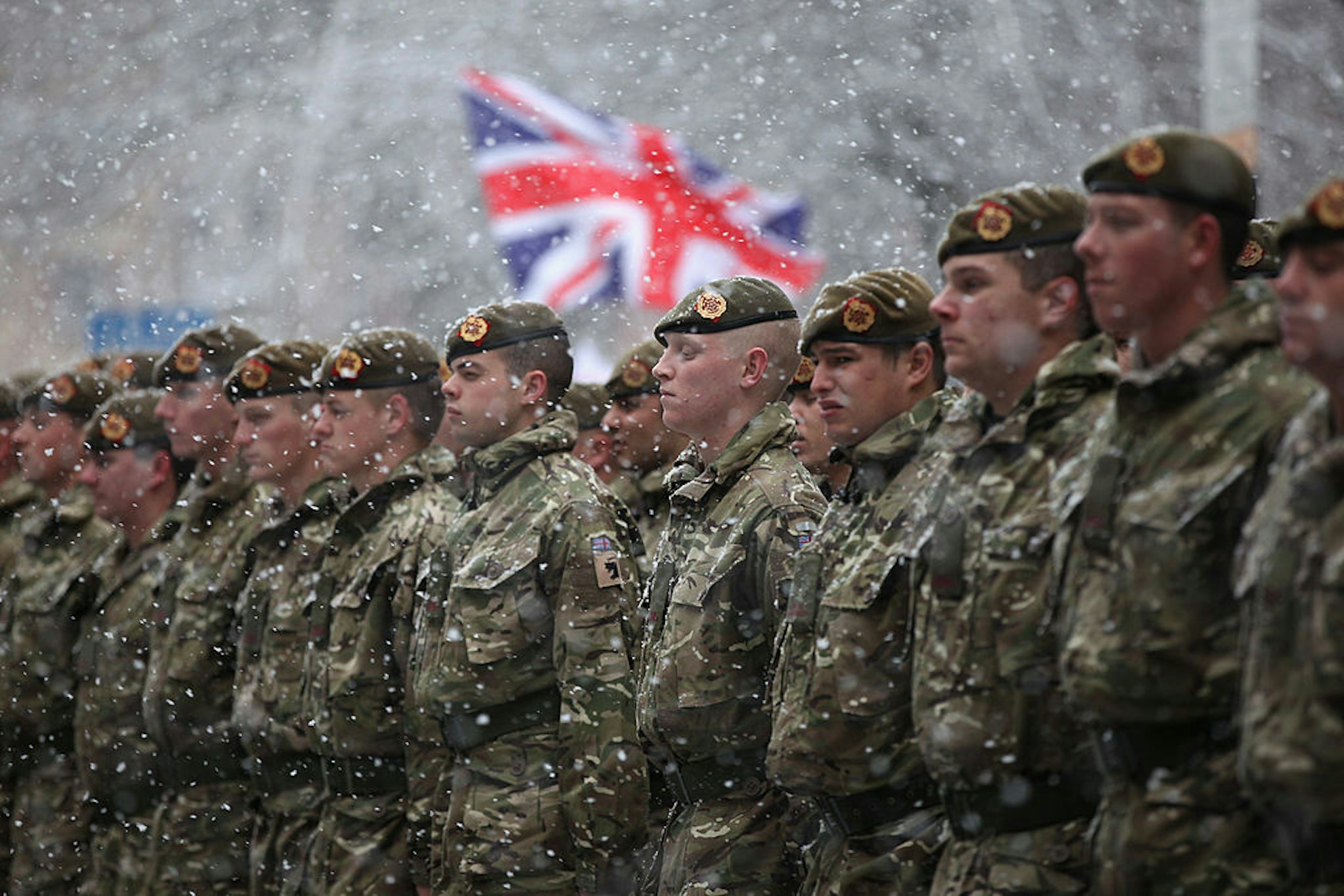 BLACKBURN, ENGLAND - DECEMBER 01: Soldiers of The 1st Battalion Duke of Lancaster's Regiment brave the snow as they march through the streets of Blackburn following a six-month tour of duty in Afghanistan on December 1, 2010 in Blackburn, England. The 120 soldiers exercised their right to the freedom of the city by taking part in a thanksgiving service at Blackburn Cathedral and parading through the streets.