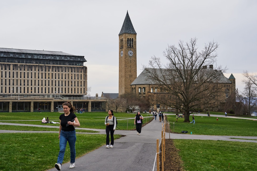 Students walk through the Arts Quad at the Cornell University campus in Ithaca, US, on Tuesday, April 11, 2023. US college costs just keep climbing and the increase is pushing the annual price for the upcoming academic year at Ivy League schools toward yet another hold-on-to-your-mortarboard mark.