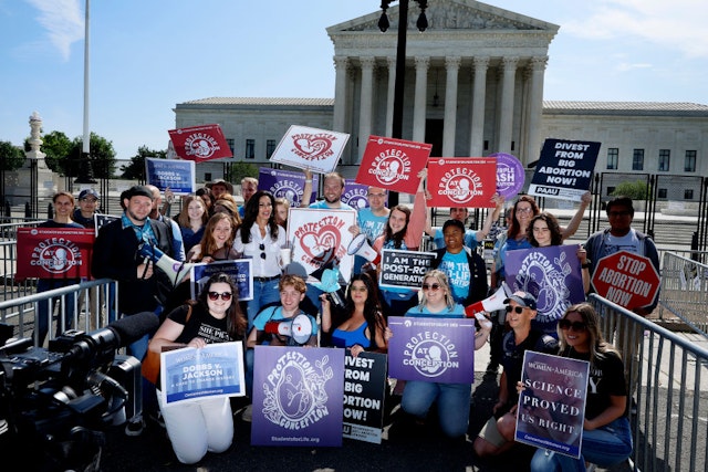 WASHINGTON, DC - MAY 23: Anti-abortion demonstrators pose for photographs outside the U.S. Supreme Court building after rallying against the landmark Roe v. Wade abortion decision on May 23, 2022 in Washington, DC. The court released opinions in Morgan v. Sundance and Shinn v. Ramirez on Monday in addition to an order list from the May 19 conference.