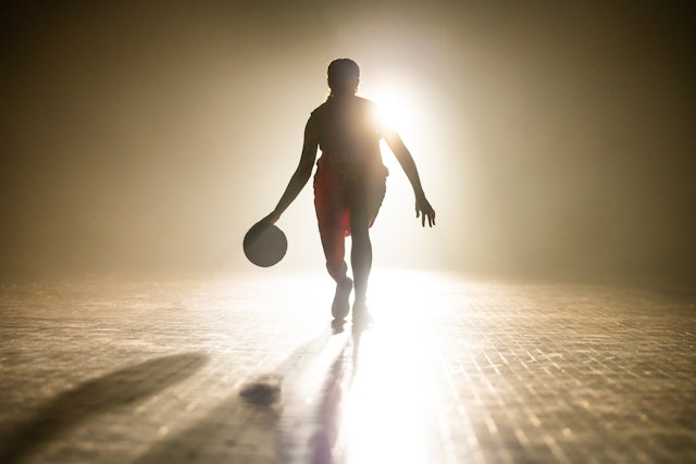 simonkr. Getty Images. Female basketball player dribbling while playing basketball alone on sports court during practice.