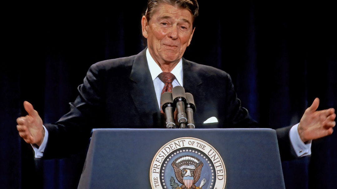 US President Ronald Reagan gestures while answering a reporters question from the podium during his 38th news conference held in the ballroom of the Hyatt Regency Hotel during a trip to the Chicago area and visiting the State Fair in Springfield earlier in the day in Chicago, Illinois on August 12, 1986 (Photo by Mark Reinstein/Corbis via Getty Images)