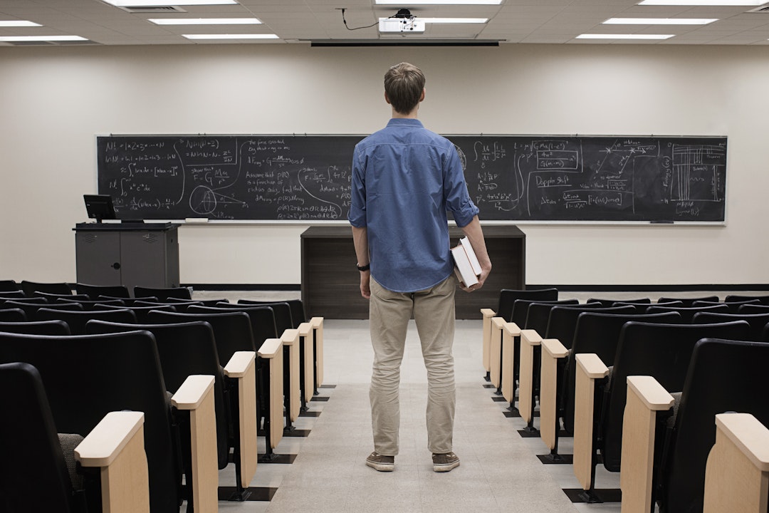 Hill Street Studios. Getty Images. Caucasian student standing in classroom.