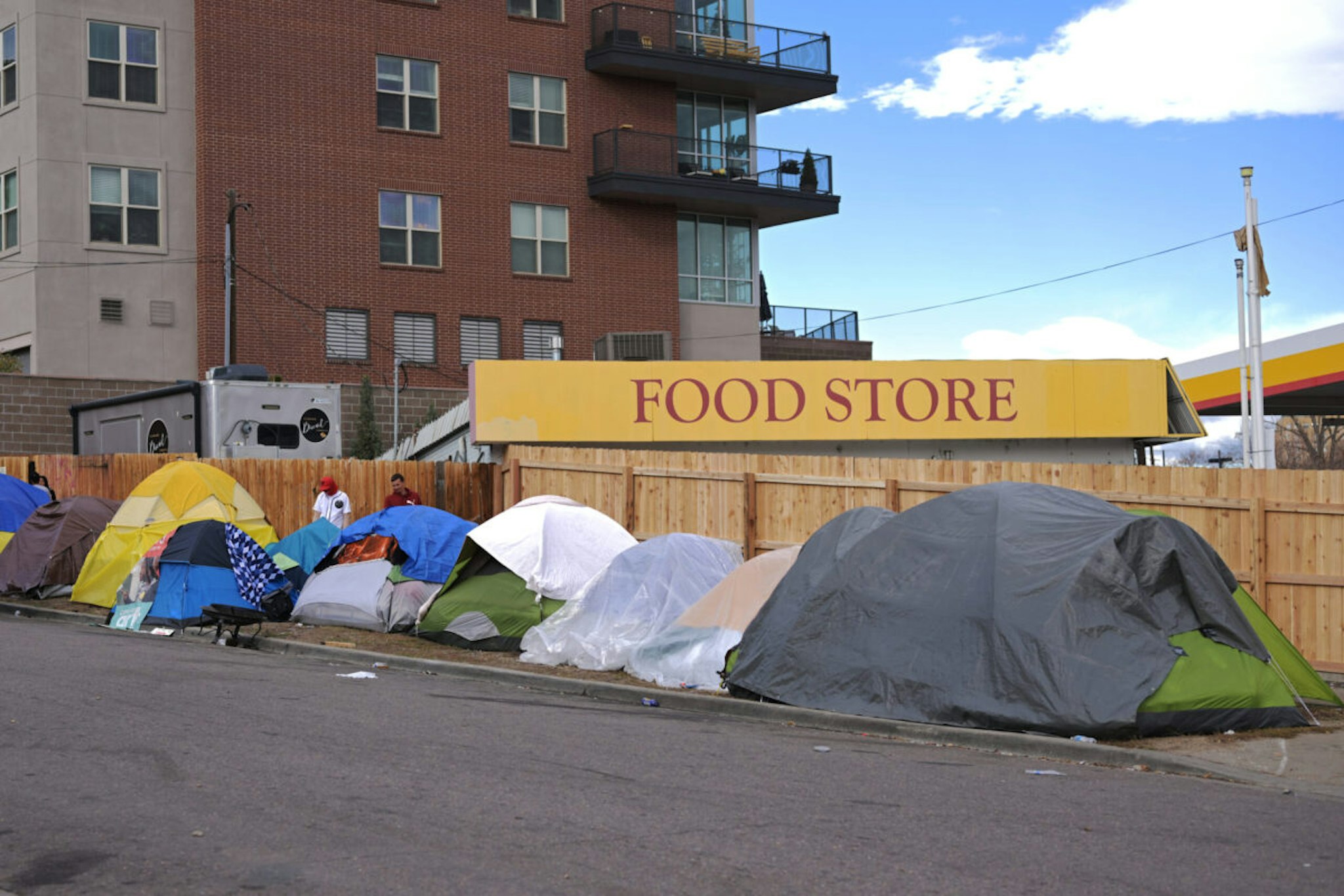 DENVER, CO - NOVEMBER 16 : People stay in the tents in front of Quality Inn Denver Downtown in Denver, Colorado on Thursday, November 16, 2023. About 2,000 people are staying in Denver's four migrant shelters in Districts 1, 8, 9 and 11.