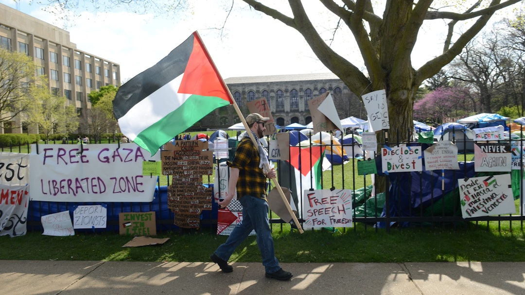 Banners hanging from the fence outside Northwestern University during a pro-Palestinian protest, expressing solidarity with Palestinians in Evanston, Illinois, United States on April 27, 2024.