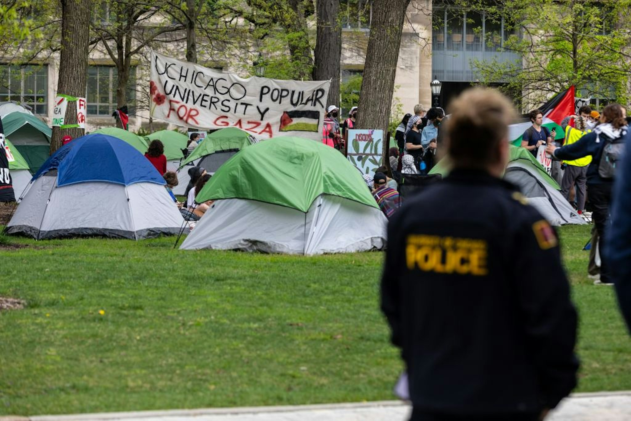 A police officer stands beside a pro-Palestine encampment on campus of the University of Chicago UChicago in Chicago, the United States, on April 29, 2024. Hundreds of UChicago students set up an encampment in the center of the campus on Monday, joining groups on over 100 university campuses across the United States in support of Palestinians.