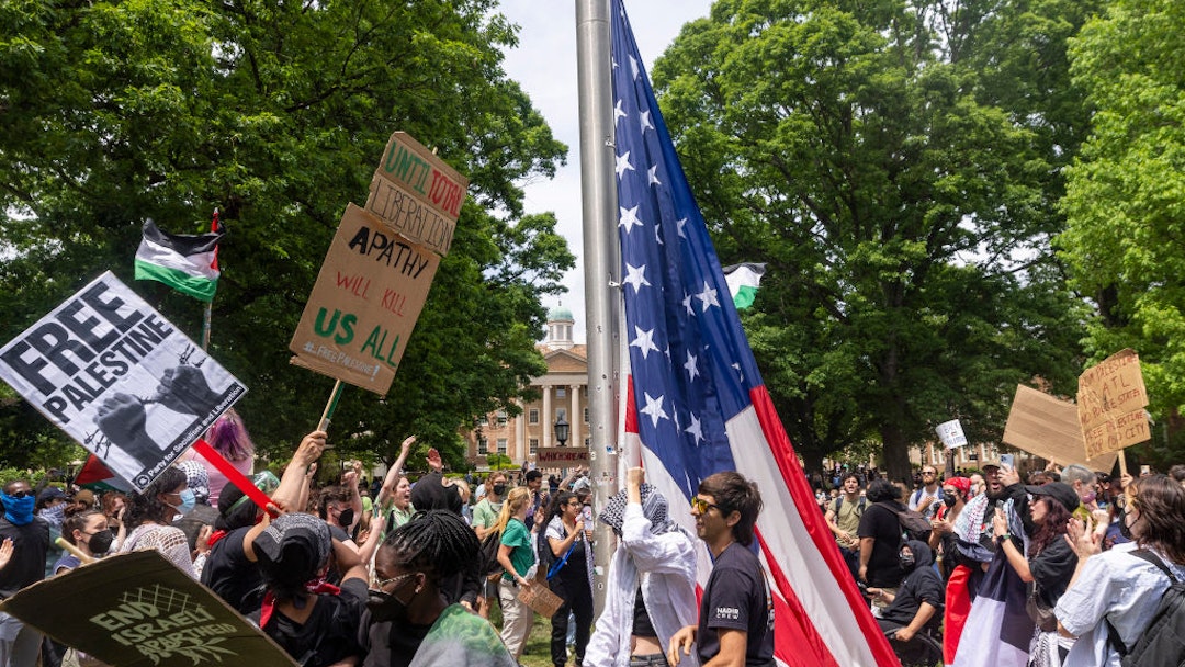 Pro-Palestinian demonstrators replace an American flag with a Palestinian flag Tuesday, April 30, 2024 at UNC-Chapel Hill. Police removed a "Gaza solidarity encampment" earlier Tuesday morning. (Travis Long/News &amp; Observer/Tribune News Service via Getty Images)