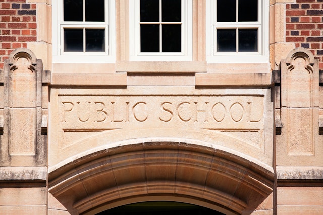 BanksPhotos. Getty Images. A Public School sign carved in granite about the entrance to an old high school.