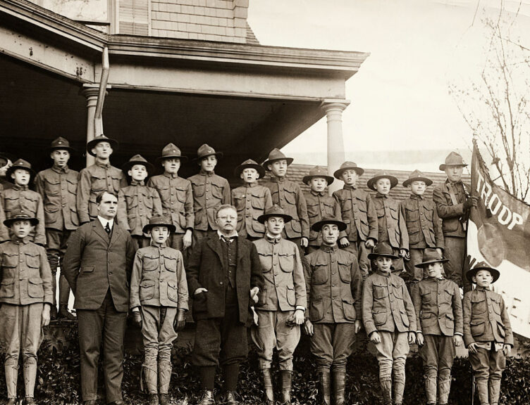 (Original Caption) Colonel Roosevelt is shown with the group of Boy Scouts of Nassau County, to whom he presented War emblems for their great work in the Liberty Loan campaign. The medals were presented at the Colonel's Home at Sagamore Hill. The medals went to boys who sold bonds in ten or more homes. The Boys sold about $100,000,000 of the bonds throughout the country, according to the reports. There were about 8,000,000 subscribers to the Loan and of these, the boys placed about 400,000 or one twentieth. (Photo by George Rinhart/Corbis via Getty Images)