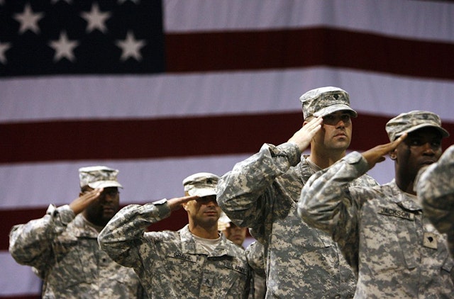 FORT RILEY, KS - SEPTEMBER 12: Soldiers stand saluting during the national anthem for the redeployment ceremony at Marshall Army Air Field inside hanger 727 for the 1st Battalion, 16th Infantry Regiment, 1st Brigade, 1st Infantry Division September 12, 2007 at Fort Riley, Kansas. The approximately 130 soldiers were returning after a one year tour in Iraq. (Photo by Larry W. Smith/Getty Images)
