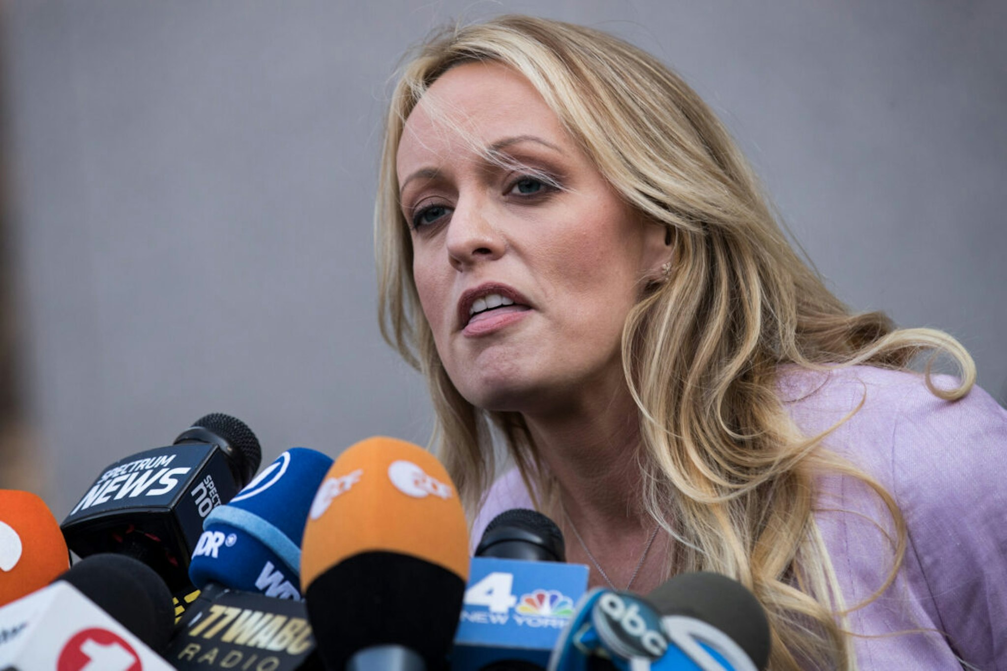 Adult film actress Stormy Daniels (Stephanie Clifford) speaks to reporters as she exits the United States District Court Southern District of New York for a hearing related to Michael Cohen, President Trump's longtime personal attorney and confidante, April 16, 2018 in New York City.