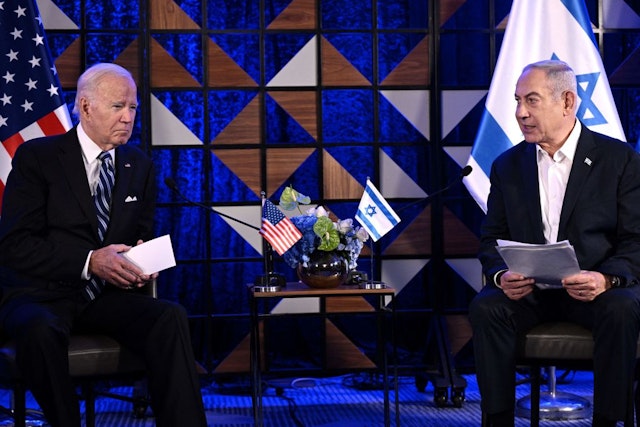 US President Joe Biden (L) listens on as Israel's Prime Minister Benjamin Netanyahu reads a statement before their meeting in Tel Aviv on October 18, 2023, amid the ongoing battles between Israel and the Palestinian group Hamas. US President Joe Biden landed in Tel Aviv on October 18, 2023 as Middle East anger flared after hundreds were killed when a rocket struck a hospital in war-torn Gaza, with Israel and the Palestinians quick to trade blame. (Photo by Brendan SMIALOWSKI / AFP) (Photo by BRENDAN SMIALOWSKI/AFP via Getty Images)