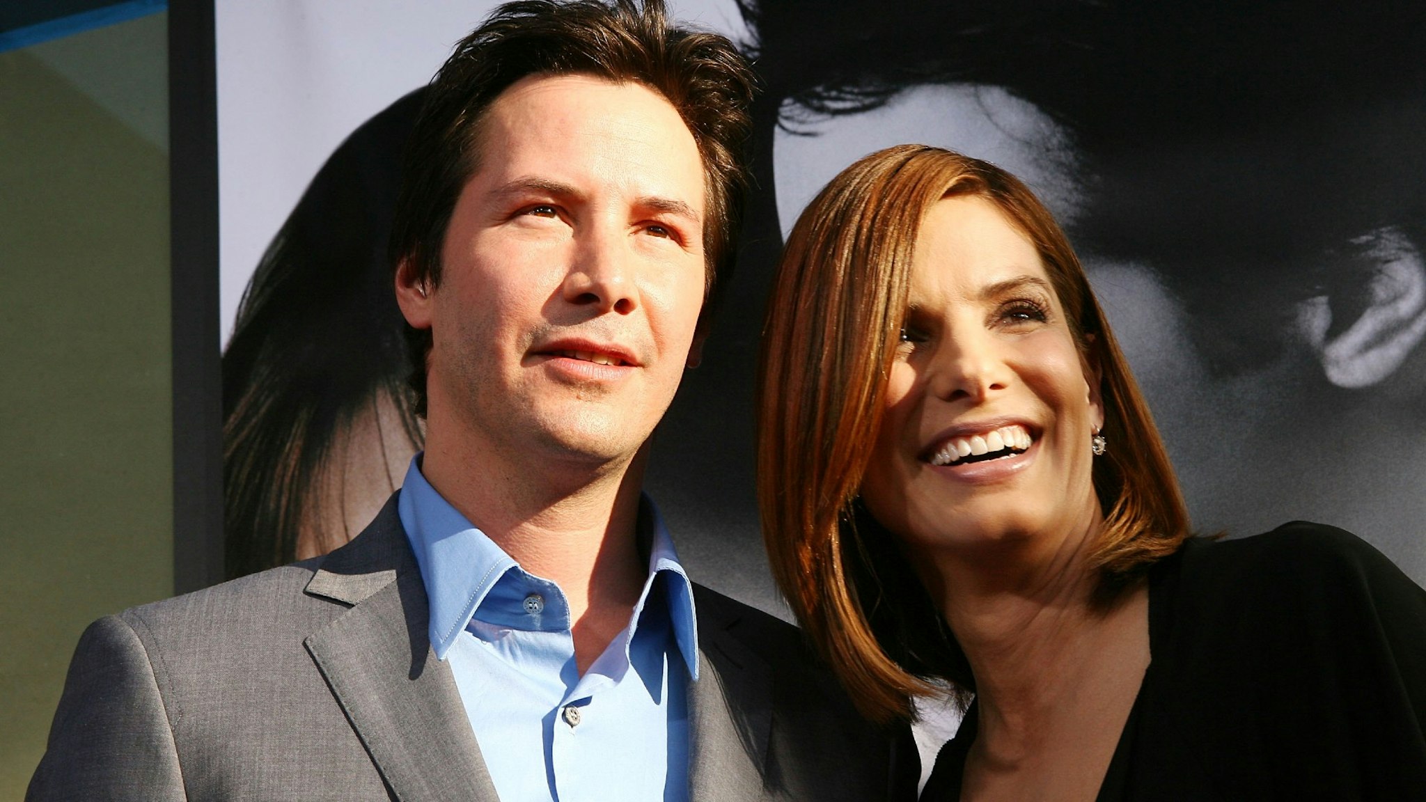 Actors Keanu Reeves (L) and Sandra Bullock arrive at the premiere of Warner Bros. Pictures' 