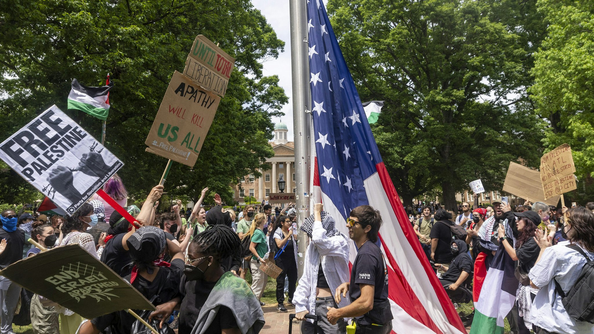 Pro-Palestinian demonstrators replace an American flag with a Palestinian flag Tuesday, April 30, 2024 at UNC-Chapel Hill. Police removed a "Gaza solidarity encampment" earlier Tuesday morning.