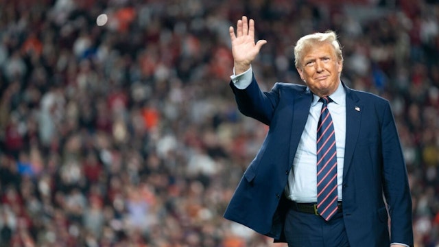 COLUMBIA, SOUTH CAROLINA - NOVEMBER 25: Former U.S. President Donald Trump waves to the crowd on the field during halftime in the Palmetto Bowl between Clemson and South Carolina at Williams Brice Stadium on November 25, 2023 in Columbia, South Carolina.