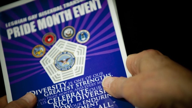 Close up of hands holding a pamphlet at the Pentagon during a Lesbian, Gay, Bi-Sexual, and Transgender Pride Month event. DOD photo by U.S. Navy Petty Officer 1st Class Chad J. McNeeley.
