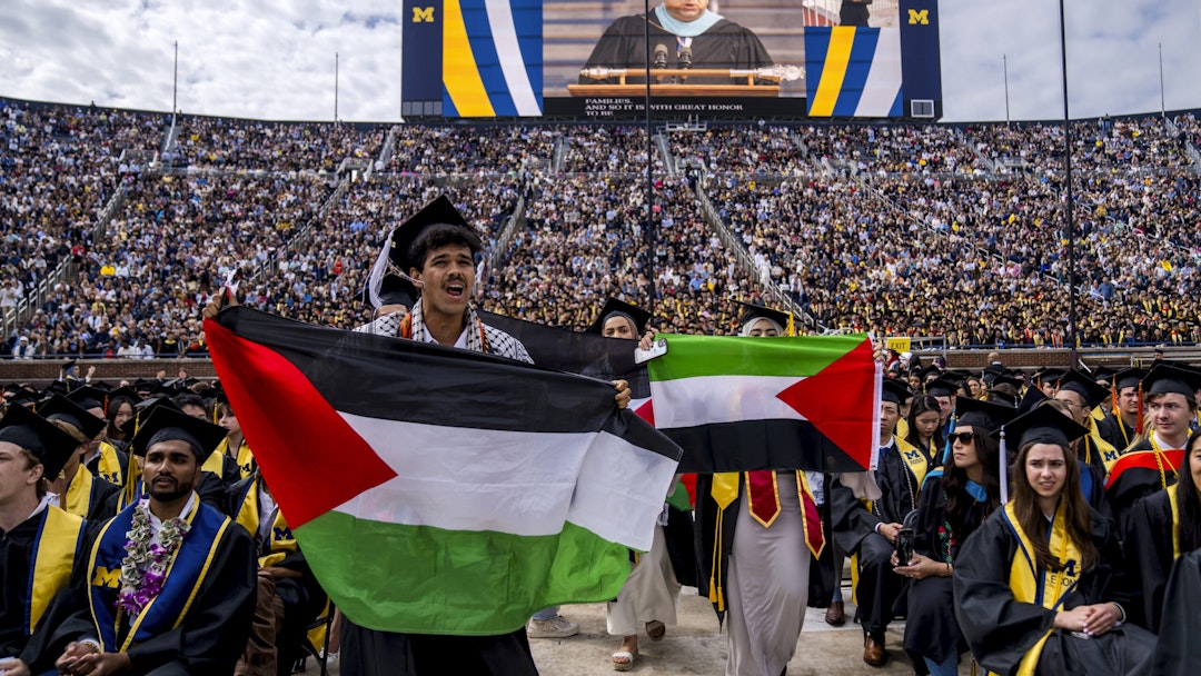 ANN ARBOR, MICHIGAN - MAY 4: Students protest in support of Palestine during the University of Michigan's Spring Commencement ceremony on May 4, 2024 at Michigan Stadium in Ann Arbor, Michigan. A group of students called for the University of Michigan to divest from companies with ties to Israel during the spring commencement ceremony.