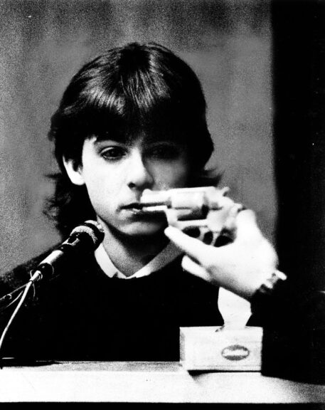 (3/12/91) Pamela Smart murder trial - William Flynn stares at the gun he used to shoot and kill Gregg Smart as AGA Paul Maggitti holds it in front of him for identification. Staff photo by Jim Mahoney (Photo by /MediaNews Group/Boston Herald via Getty Images)