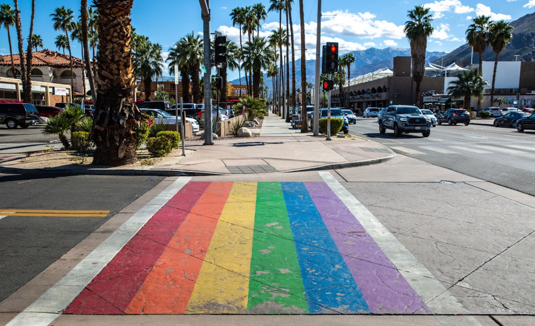 PALM SPRINGS, CA - MARCH 7: The street pedestrian crossing is painted in rainbow colors as viewed on March 7, 2022 in Palm Springs, California. Palm Springs is a city of nearly 50,000 that has become an important tourist destination for the LGBTQ community as well as a relaxed environment for older retirees. This desert resort city is located 2 hours east of Los Angeles in Riverside County within the Colorado Desert's Coachella Valley. (Photo by George Rose/Getty Images)