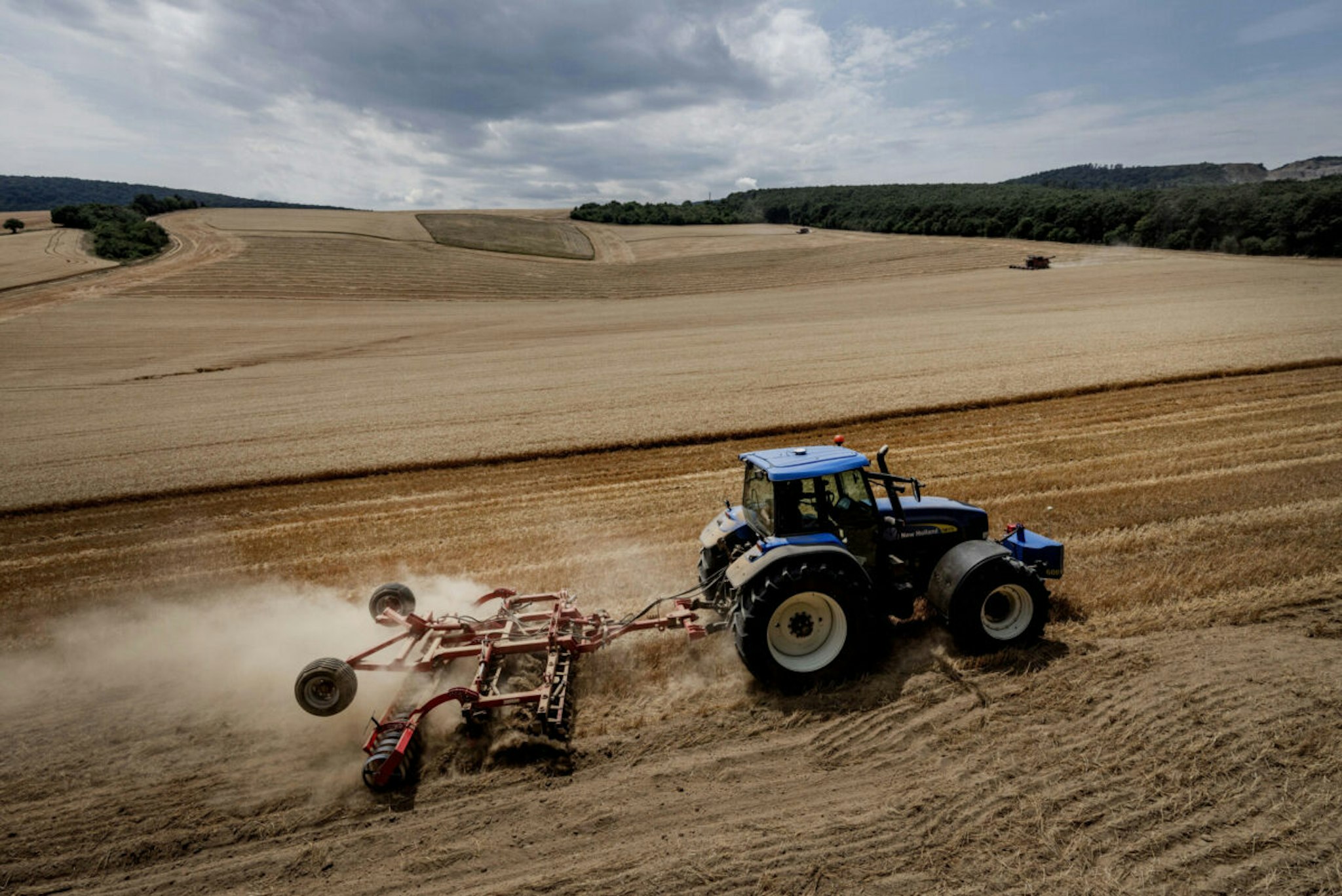 PUSZTAMAROT, HUNGARY - JULY 07: A tractor plows the ground at the end of wheat harvesting on July 7, 2022 in Pusztamarot, Hungary. Hungary recently banned grain exports amid surging global wheat prices, caused by Russia's invasion of Ukraine. Russia and Ukraine are among the world's two largest wheat exporters.