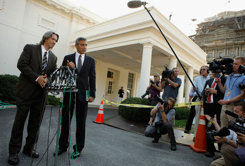 WASHINGTON - OCTOBER 12: Oscar-nominated actor, screen-writer and director George Clooney (R) and human rights activist and co-founder of the Enough Project John Prendergast answer reporters' questions after meeting with U.S. President Barack Obama at the White House October 12, 2010 in Washington, DC. Clooney and Prendergast met with Obama to discuss their recent trip to Sudan and the threat there of a war ahead of a referendum election. (Photo by Chip Somodevilla/Getty Images)