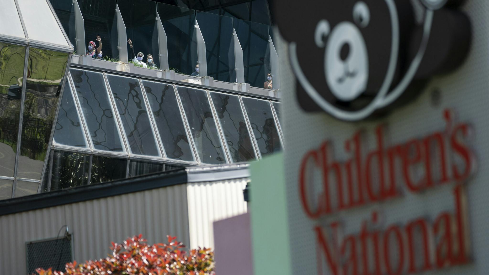 Children’s National Hospital Hospital staff from Children's National Hospital watch as the U.S. Navy Blue Angels and U.S. Airforce Thunderbirds fly over the D.C. area on May 2, 2020 in Washington, DC.