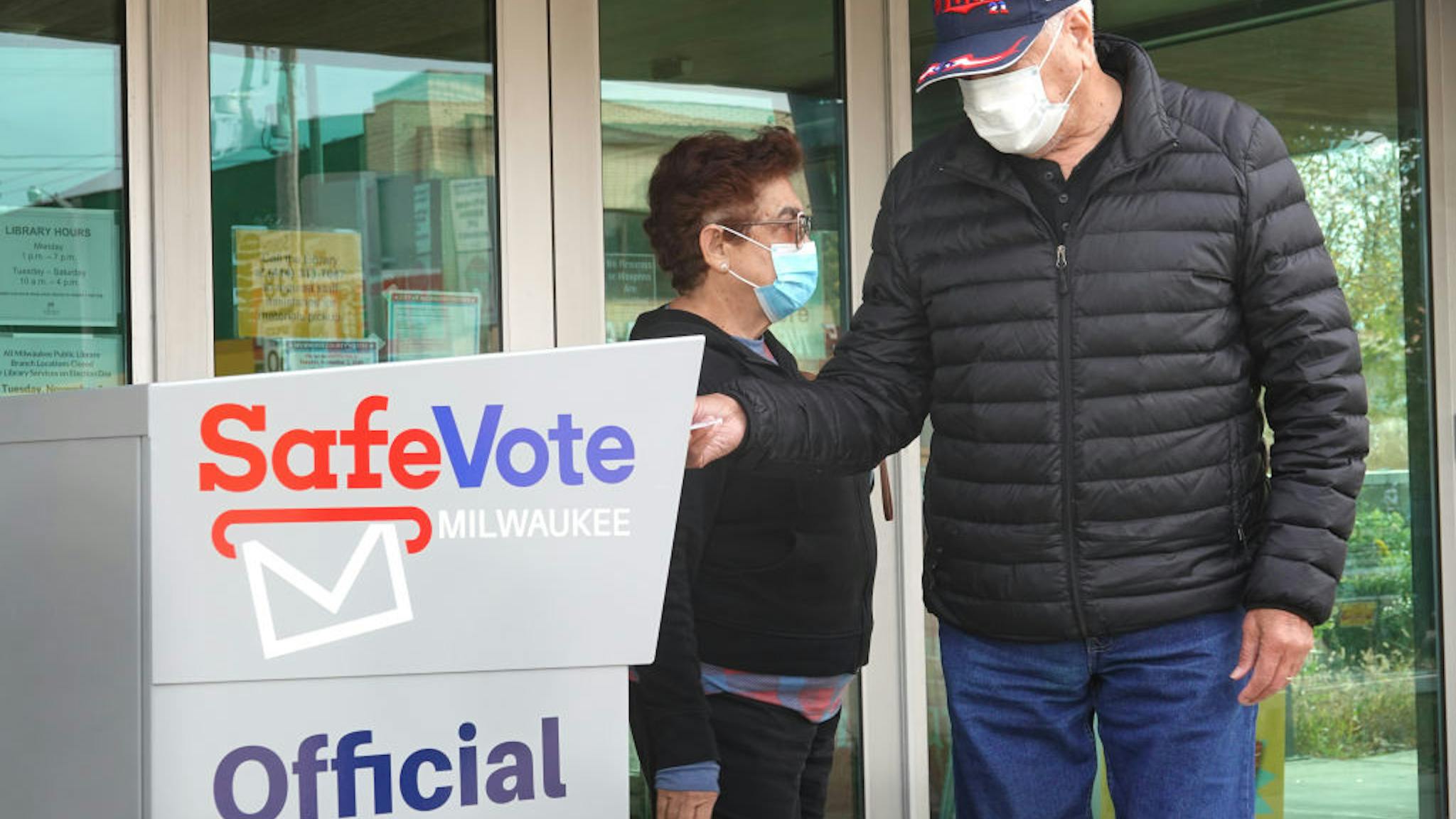 Early Voting Begins In Swing State Of Wisconsin MILWAUKEE, WISCONSIN - OCTOBER 20: Residents drop mail-in ballots in an official ballot box outside of the Tippecanoe branch library on October 20, 2020 in Milwaukee, Wisconsin. Today is the first day of early voting in Wisconsin, which is considered a battleground state for the 2020 presidential election.