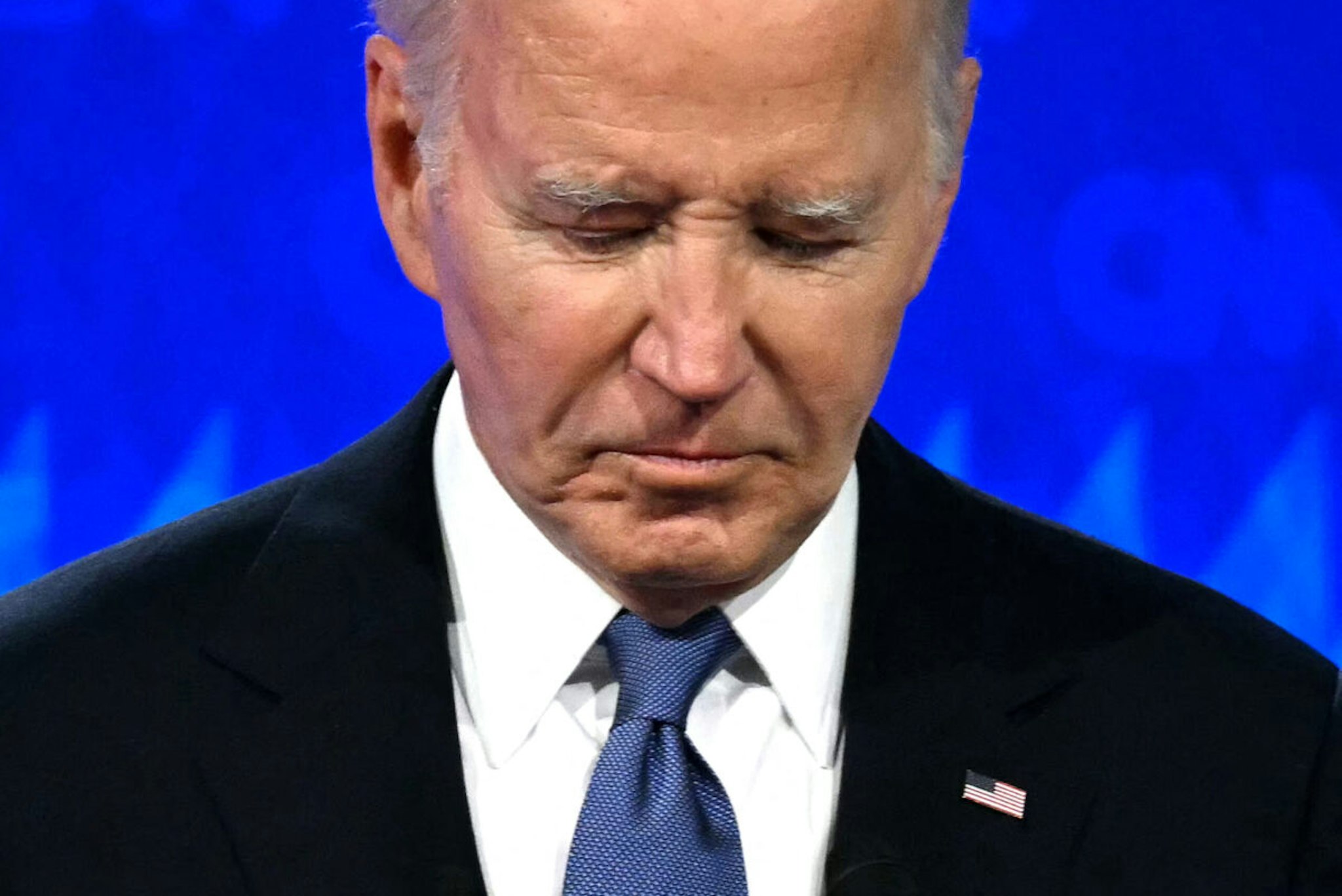 TOPSHOT - US President Joe Biden looks down as he participates in the first presidential debate of the 2024 elections with former US President and Republican presidential candidate Donald Trump at CNN's studios in Atlanta, Georgia, on June 27, 2024.