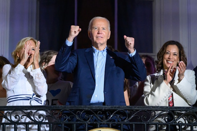 TOPSHOT - US President Joe Biden (C) gestures next to First Lady Jill Biden (L) and US Vice President Kamala Harris as they watch the Independence Day fireworks display from the Truman Balcony of the White House in Washington, DC, on July 4, 2024. (Photo by Mandel NGAN / AFP) (Photo by MANDEL NGAN/AFP via Getty Images)