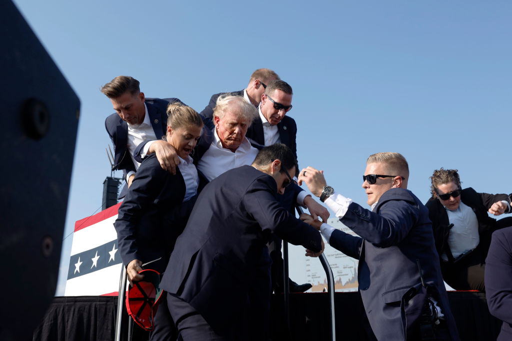 Journalist Captures Photo Of Bullet Whizzing Past Trump’s Head After It Hit His Ear