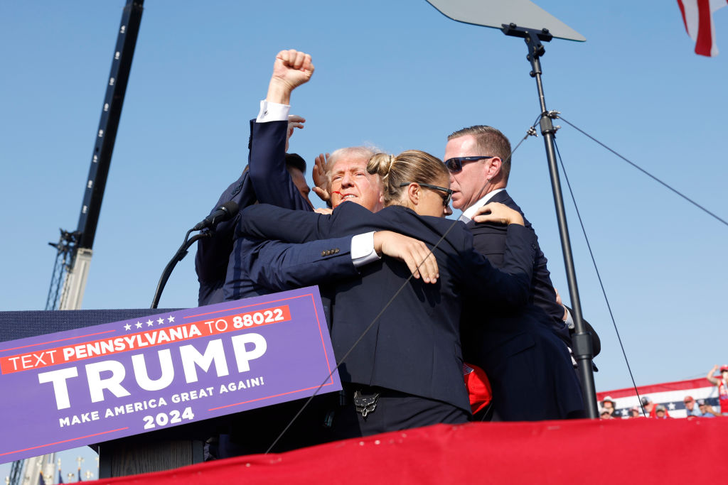 Journalist Nabs Photo Of Bullet Whizzing Past Trump After Hitting His Ear