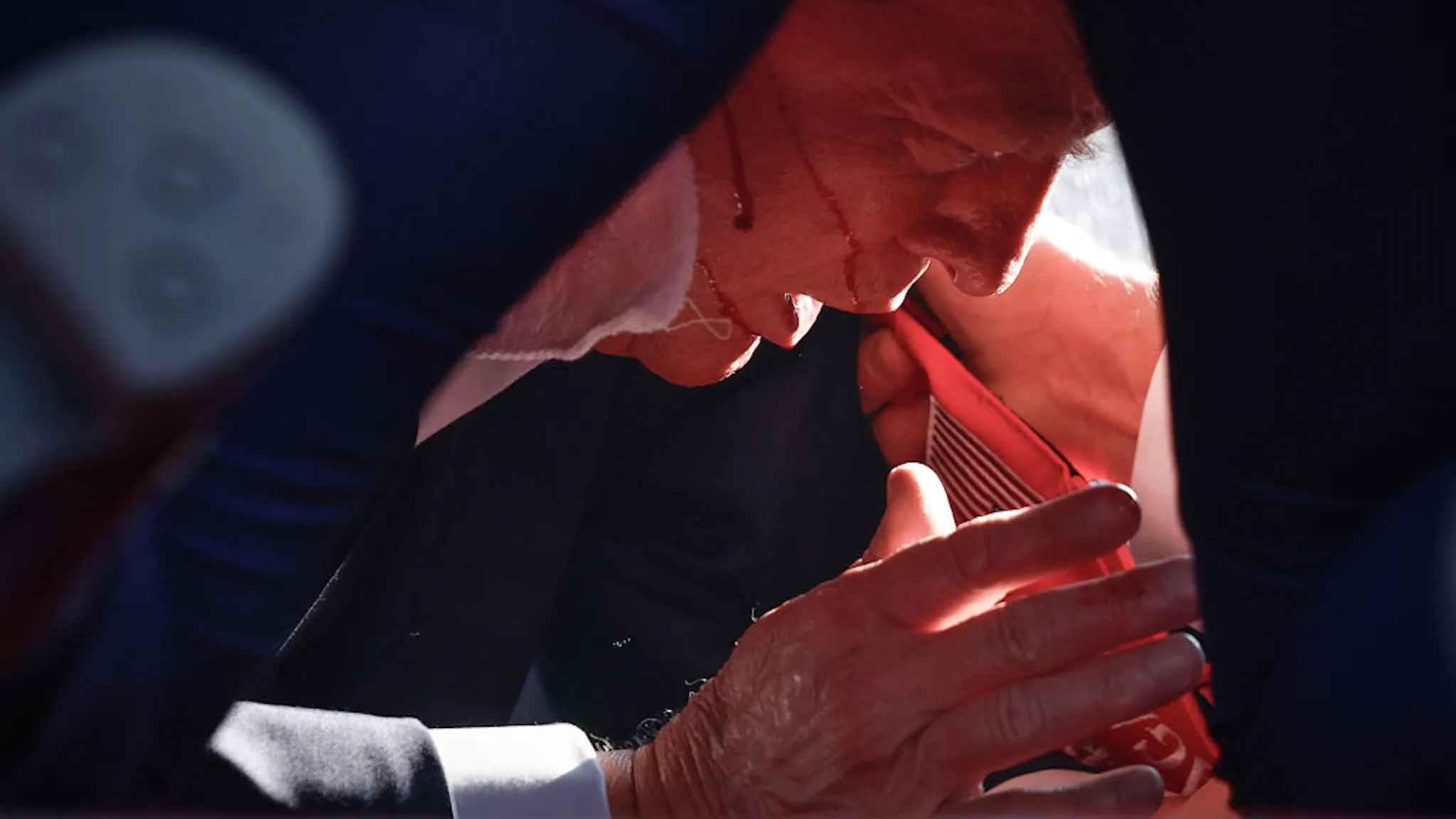 Donald Trump Holds A Campaign Rally In Butler, Pennsylvania BUTLER, PENNSYLVANIA - JULY 13: Republican presidential candidate former President Donald Trump is shown covered by U.S. Secret Service agents after an incident during a rally on July 13, 2024 in Butler, Pennsylvania.
