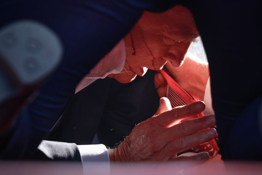 BUTLER, PENNSYLVANIA - JULY 13: Republican presidential candidate former President Donald Trump is shown covered by U.S. Secret Service agents after an incident during a rally on July 13, 2024 in Butler, Pennsylvania. 