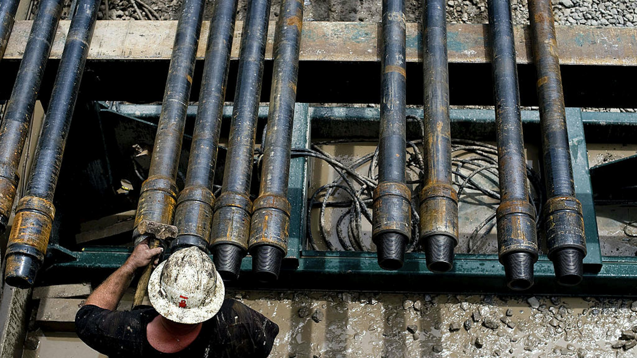Oil And Gas Exploration In The Marcellus Shale A drill hand prepares drill pipe as a shale-gas well is drilled in Mannington, West Virginia, U.S., on Friday, April 30, 2010. This well was being drilled into the Marcellus Shale, a formation that may hold 262 trillion cubic feet of recoverable natural gas, making it the largest known deposit according to a U.S. Energy Department estimate.