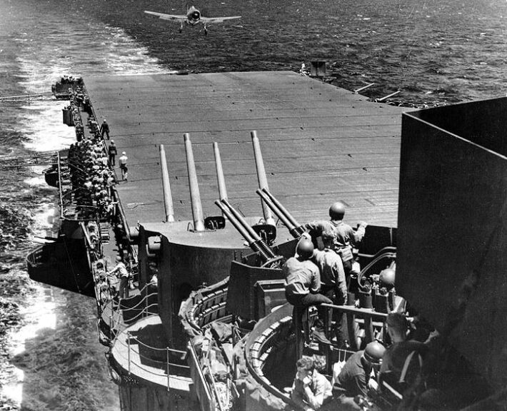 Grumman F6F-3 fighter landing aboard the Essex Class carrier USS Lexington (CV-16) - flagship of Task Force 58 - during the Battle of the Philippine Sea, June 1944. Official US Navy Photograph. (Enhancement by DLJ - Wild Surmise). Wikimedia Commons.