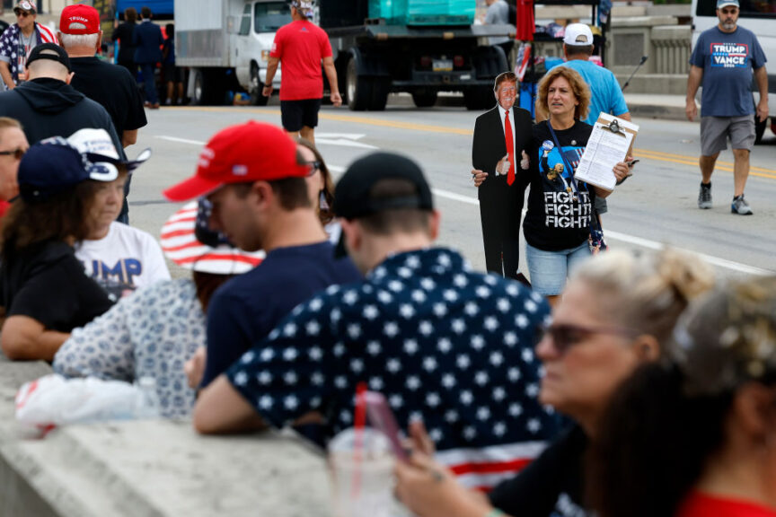 JOHNSTOWN, PENNSYLVANIA - AUGUST 30: A woman offers to register voters as people wait in line to attend a campaign rally with Republican presidential nominee, former U.S. President Donald Trump at the Cambria County War Memorial on August 30, 2024 in Johnstown, Pennsylvania. Trump is scheduled to hold a campaign rally at the memorial's 1st Summit Arena in Johnstown near the heart of the battleground state of Pennsylvania. (Photo by Chip Somodevilla/Getty Images)