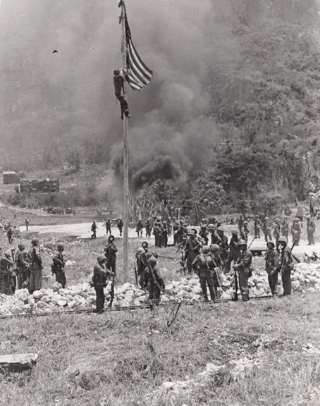 Raising the flag at Marpi airfield, 9 July 1944. USMC photo by Sgt. Nick Ragus. Courtesy: 1-24thmarines.com