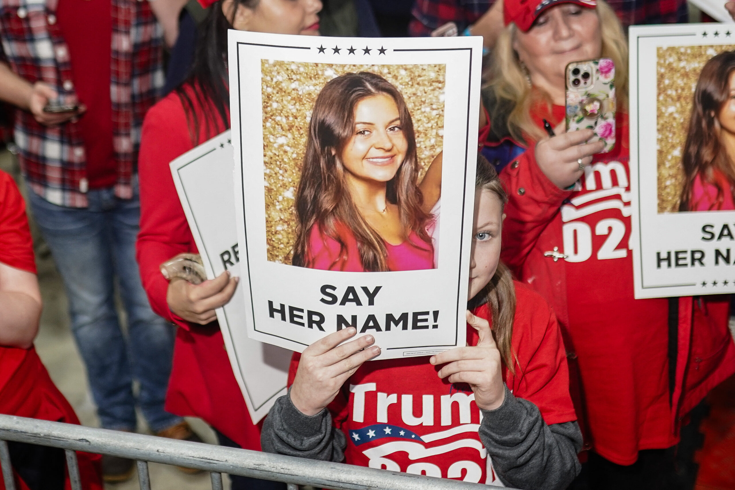 Supporters of former US President and 2024 presidential candidate Donald Trump hold images of Laken Riley before he speaks at a "Go vote" rally in Rome, Georgia, on March 9, 2024. Riley, a nursing student, has become the face of immigration reform after her murder, allegedly by an illegal immigrant, on February 22, 2024. (Photo by Elijah Nouvelage / AFP) (Photo by ELIJAH NOUVELAGE/AFP via Getty Images)