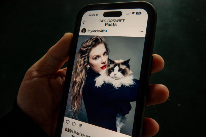 BATH, UNITED KINGDOM - SEPTEMBER 12: In this photo illustration a man looks at the post by Taylor Swift endorsing Democratic Presidential candidate Kamala Harris on the online social media and social networking site Instagram displayed on a smart phone on September 12, 2024 in Bath, England. Taylor Swift posted her support to her 283 million followers with a picture of her holding a cat after the vice president finished her debate with Donald Trump on ABC News. (Photo by Matt Cardy/Getty Images)